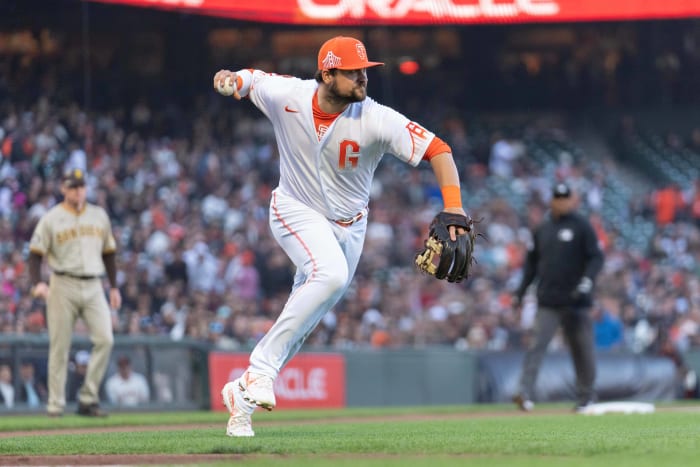 SF Giants third baseman J.D. Davis throws the ball during the third inning against the San Diego Padres at Oracle Park on June 20, 2023.